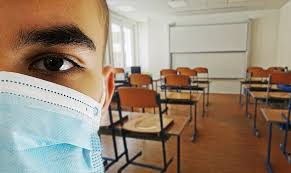 Image of a student with a COVID mask on in a classroom.